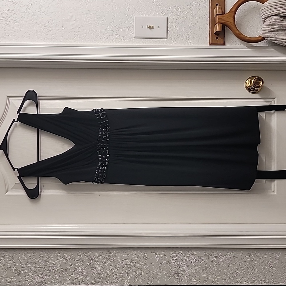 Black sleeveless party dress with bling/gem design, midi length, size 4